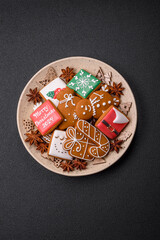 Beautiful Christmas gingerbread cookies of different colors on a ceramic plate