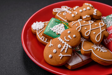 Beautiful Christmas gingerbread cookies of different colors on a ceramic plate