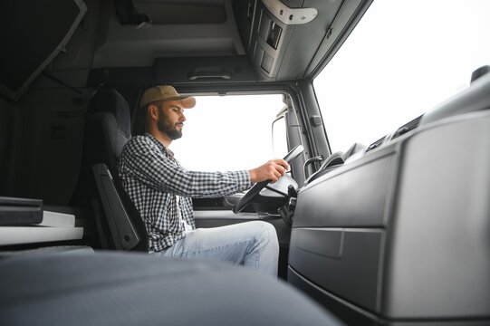 Close up of truck driver behind steering wheel. Copy space