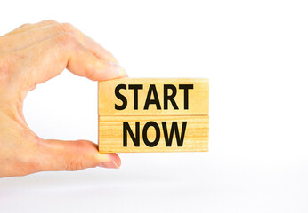 Start now symbol. Concept words Start now on beautiful wooden block. Beautiful white table white...