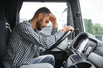Man trucker tired driving in a cabin of his truck