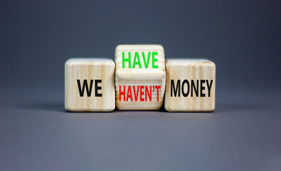 We have or not money symbol. Concept word We have or have not money on beautiful wooden cubes. Beautiful grey table grey background. Business and we have or not money concept. Copy space.