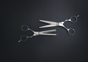 Professional Haircutting Scissors. Open hairdresser scissors on a black background. Professional tool for hairdressers scissors.