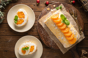 Meringue roll cake with cream, tangerine.