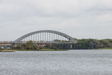 Fototapeta na wymiar Railway bridge over the river Lek near the city of Culemborg.