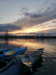 Kayaks observing the sun set on a Louisiana bayou in fall.
