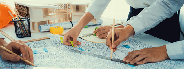 Worker, architect and engineer work on real estate construction project oratory planning with...