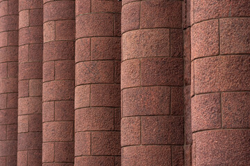 architectural background - massive granite engaged columns on the facade of the building