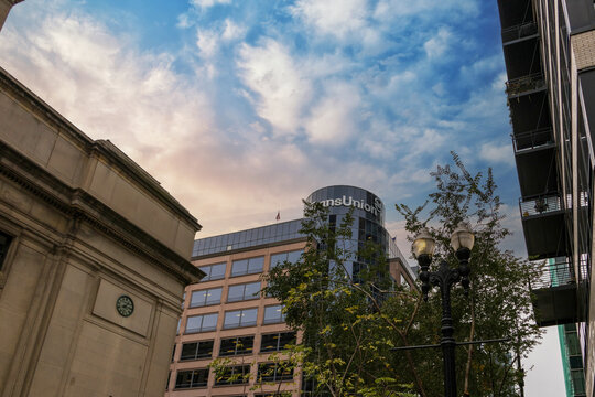 The TransUnion buildings next to Chicago Union Station and apartments with balconies, lush green trees and tall black light posts in downtown in Chicago Illinois USA
