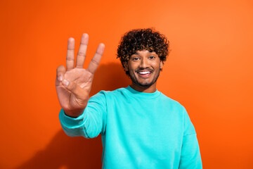 Close up portrait of handsome indian young guy showing three fingers countdown before sales start...