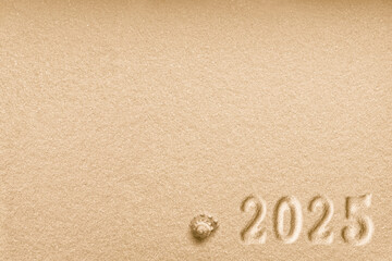 Imprints of numbers 2025 new year and a shell left side on a golden sand