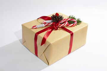 Christmas, New Year gifts. Presents. Beautiful boxes, ribbons and decorations. tree cones on white background. red. craft paper. Holiday. original. cinnamon. candy. Package Design