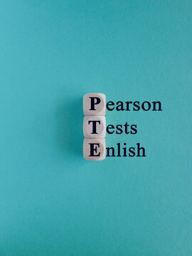 PTE - acronym on wooden cubes with letters, Pearson Tests of English PTE concept Foreign Language exams.