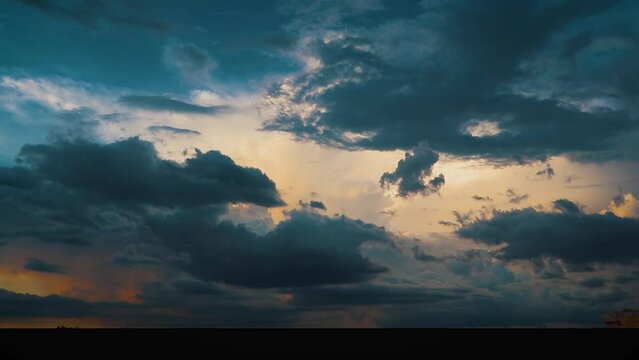 Time-lapse footage of puffy blue clouds in the sky in Narmada, India, at sunset