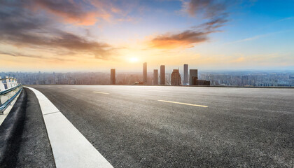 panoramic city skyline and buildings with empty asphalt road at sunset - Powered by Adobe