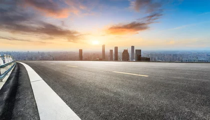 Foto op Canvas panoramic city skyline and buildings with empty asphalt road at sunset © Debbie