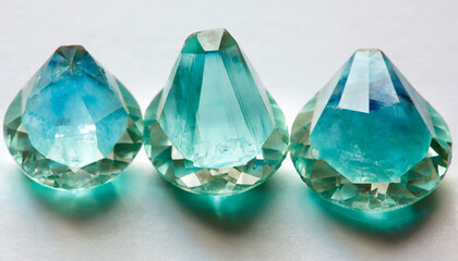 Fototapeta premium vibrant aquamarine crystal gemstone trio on white background