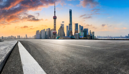 Fototapeta na wymiar asphalt road and city skyline with modern buildings in shanghai at sunrise china panoramic view