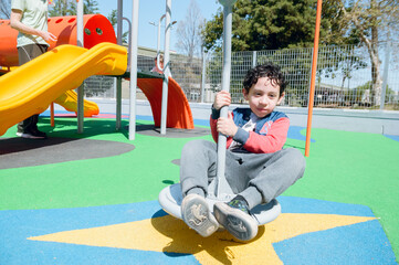 young latin boy playing in park