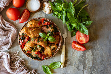 Baked chicken with vegetables on a beautiful plate. View from above. Grilled chicken with vegetables for lunch. Close-up
