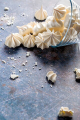 Small white meringues on a colored background