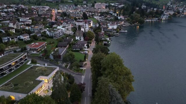 Bird's eye view of Weggis on shore of Lucerne lake in Switzerland shot in time lapse in twilight