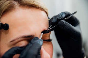 The makeup artist performs long-term eyebrow styling and paints the eyebrows. Lamination of...