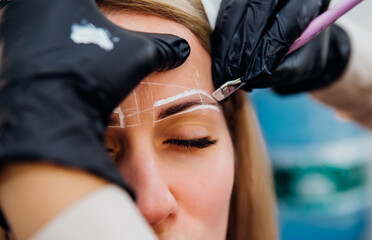 The makeup artist performs long-term eyebrow styling and paints the eyebrows. Lamination of...