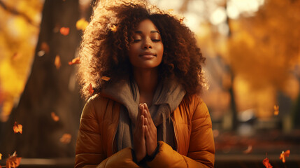 Outdoor portrait of young attractive African american woman practicing mindfulness, meditation, breathing, nurturing. Mental health concept
