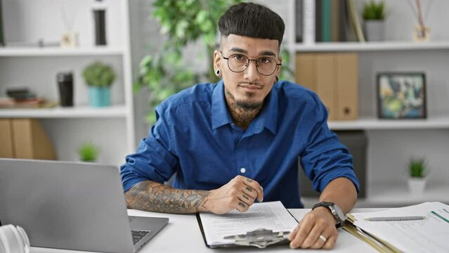 Serious young latin man, a working professional in the office, hands over his business contract