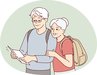 Smiling mature couple look at map traveling