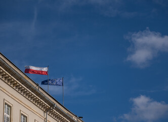 Fototapeta na wymiar the Polish flag and the flag of the European Union on the building