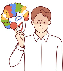 Angry man takes off mask of happy clown for concept of duplicity and hypocrisy of person
