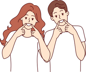 Happy man and woman smile broadly and raise fingers to mouths, recommending use whitening toothpaste