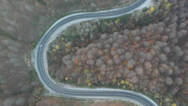 Curvy mountain roads in autumn. Vehicles in motion on winding mountain roads. 