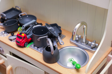 Naklejka premium Children's colorful toys, tiny legs, and building blocks scattered on the floor, a playful scene of early childhood development