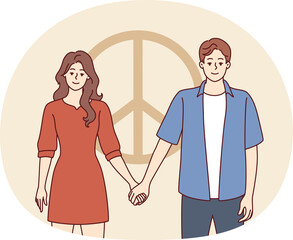 Man and woman dressed in casual style hold hands standing near symbol of pacifism. Vector image
