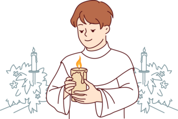 Boy participates in holy communion and holds burning candle for christian religious ritual in church