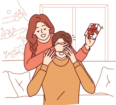 Woman gives christmas gift to boyfriend sitting on sofa and closes eyes to make surprise