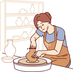 Woman sits in pottery workshop and sculpts jug from clay to sell handmade souvenirs