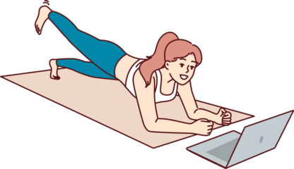 Woman is doing fitness lying on yoga mat and looking at laptop, listening to advice online trainer