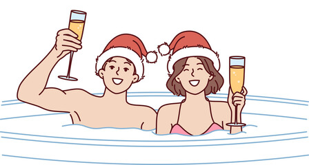 Couple drinks champagne sitting in hot tub on christmas eve and enjoying romantic setting