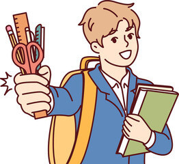 Little boy from primary school with smile demonstrates stationery and books, standing with backpack