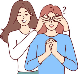Happy woman closes sisters eyes, coming up from behind and making surprise, asking riddle who it is