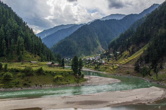 Picture of Mountain, Trees, River and Stream of adjoining areas of Kashmir. In this picture you can see the hill view along with stream and trees with beautiful scene of greenery on mountains