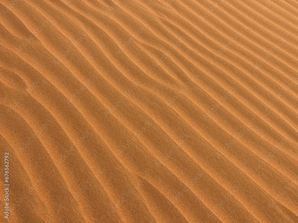 Wall mural Closeup shot a wavy brownish sand texture, backgrounds and wallpapers