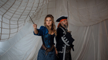 A lady with a dagger and a pirate in an old doublet with a saber, a battle with enemies, a pirate...