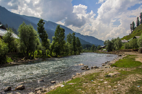 Picture of Mountain, Trees, River and Stream of adjoining areas of Kashmir. In this picture you can see the hill view along with stream and trees with beautiful scene of greenery on mountains