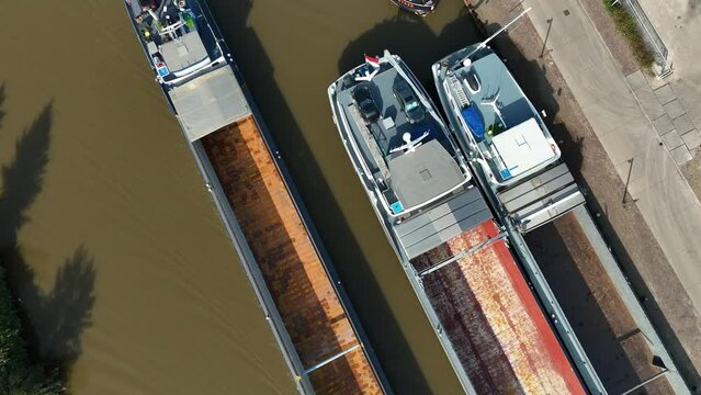 empty cargo ship seen from above on the Twente canal in the netherlands