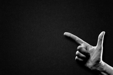 Hand Pointing Sign in Black and White on Textured Paper Background, Copy Space